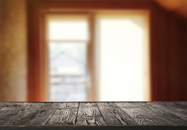 Empty wooden surface and blurred view of modern window 