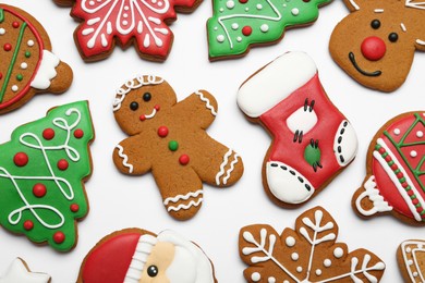 Different tasty Christmas cookies on white background, flat lay