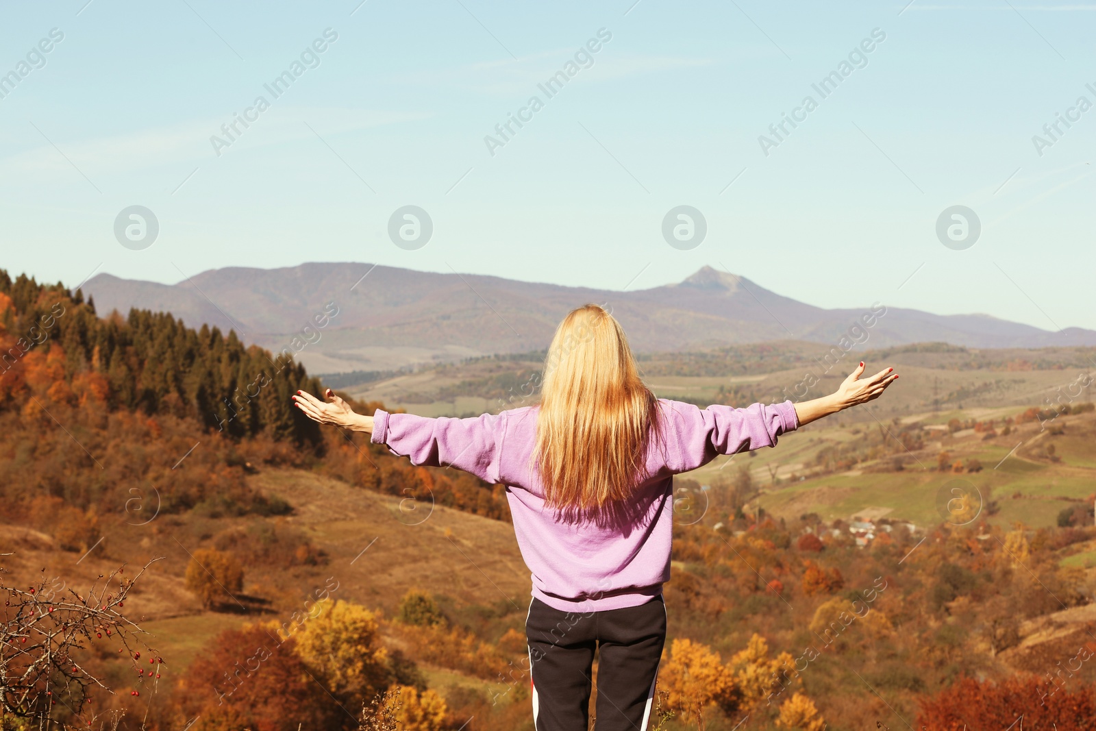 Photo of Female traveler feeling free in peaceful mountains