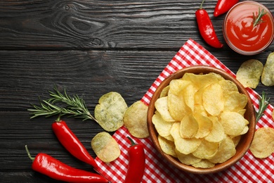 Photo of Flat lay composition with potato chips and sauce on wooden table. Space for text