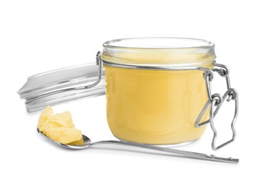 Photo of Glass jar and spoon of Ghee butter isolated on white