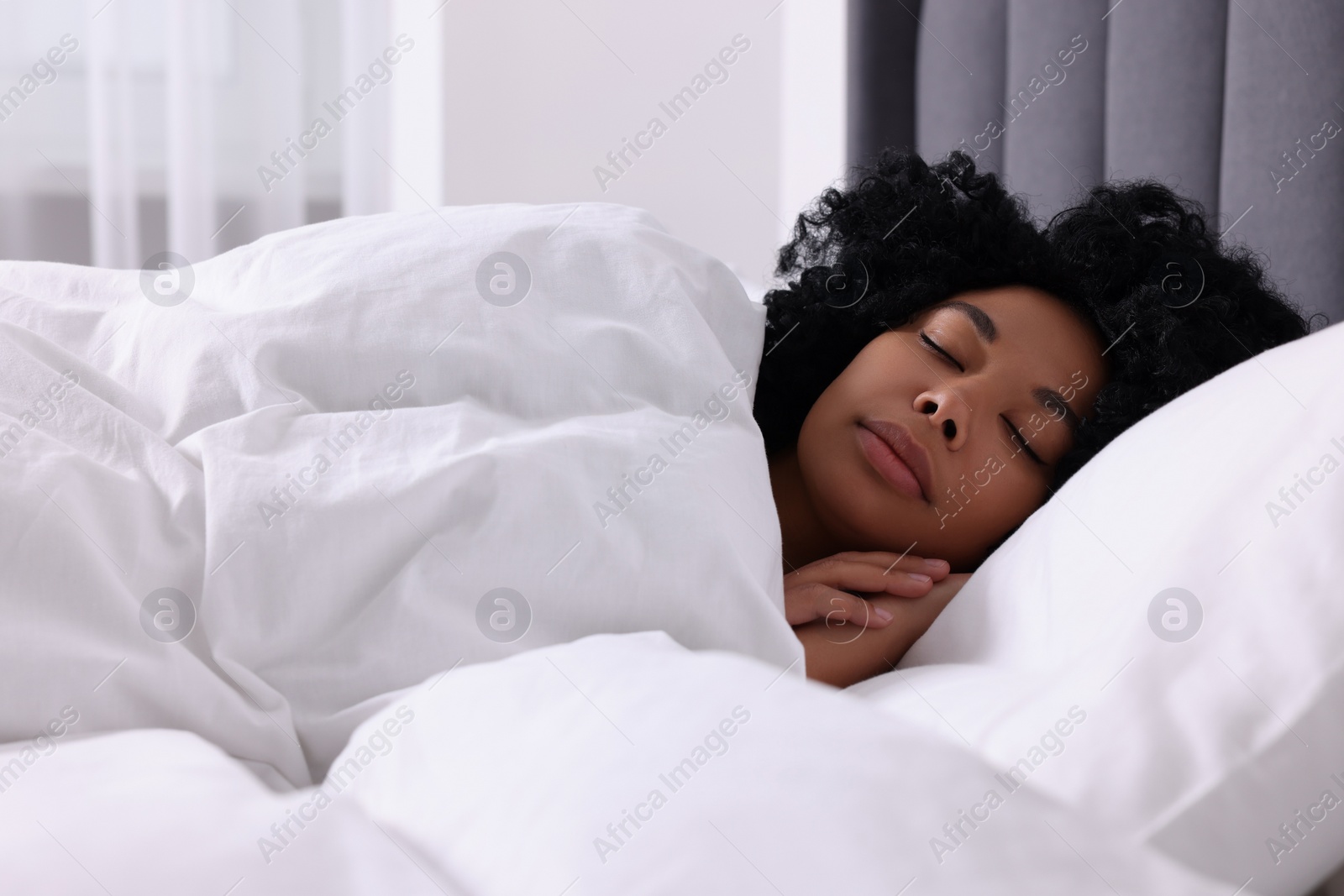 Photo of Beautiful young woman sleeping in soft bed at home