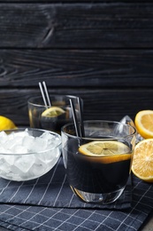 Glasses with natural black lemonade on table