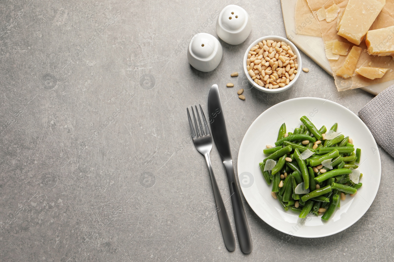Photo of Tasty salad with green beans served on light grey table, flat lay. Space for text