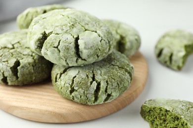 Board with tasty matcha cookies on white table, closeup