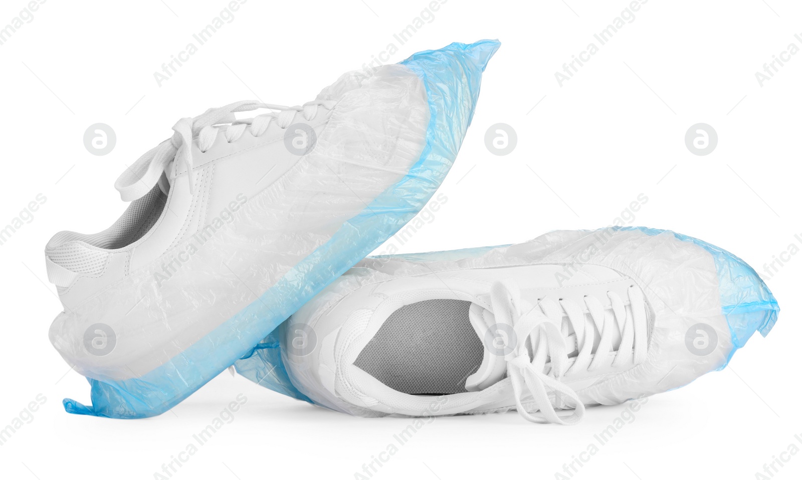 Photo of Sneakers in shoe covers isolated on white