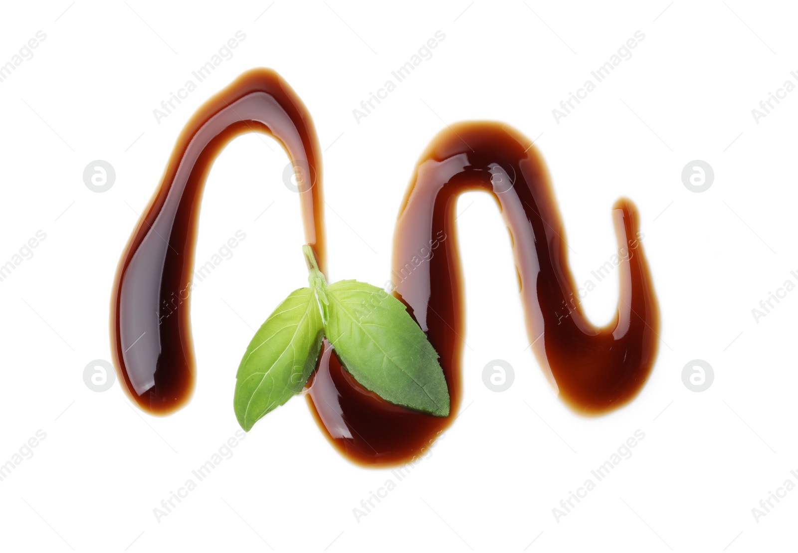 Photo of Balsamic glaze and basil leaves on white background, top view