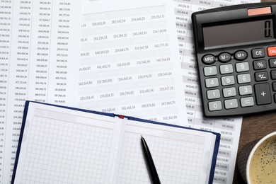 Photo of Calculator, notebook and documents with data on table, flat lay