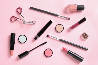 Photo of Flat lay composition with products for decorative makeup on pastel pink background