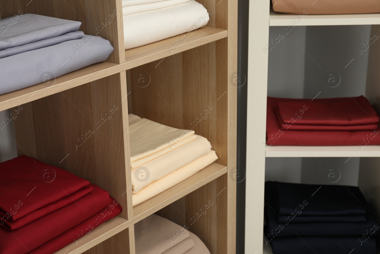 Photo of Different colorful bed linens on display in home textiles store