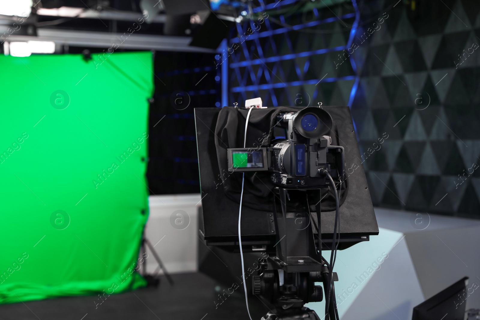 Photo of Modern video recording studio with professional equipment, focus on camera