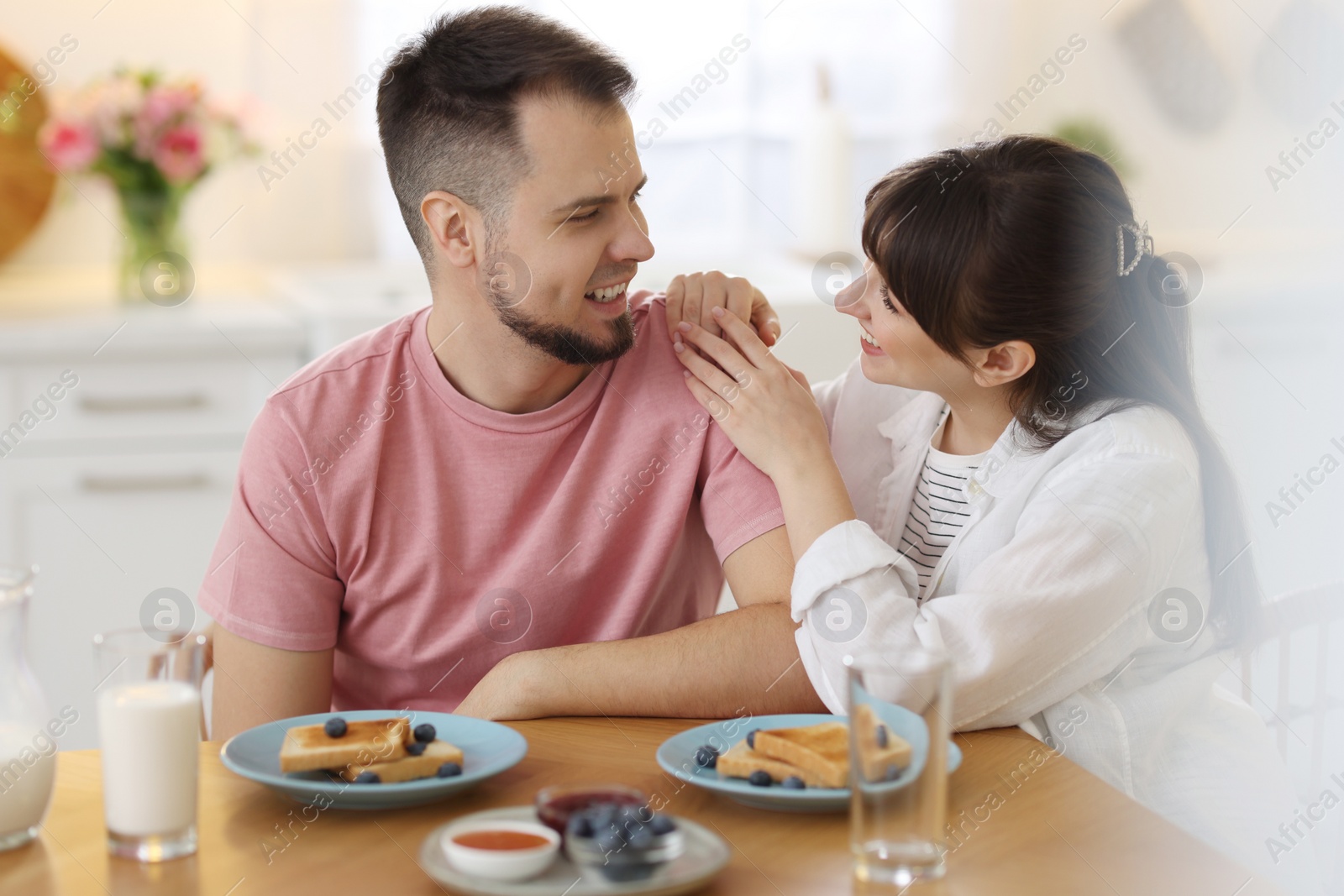 Photo of Lovely couple spending time together during breakfast at home