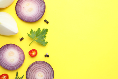 Photo of Flat lay composition with onion and spices on yellow background. Space for text