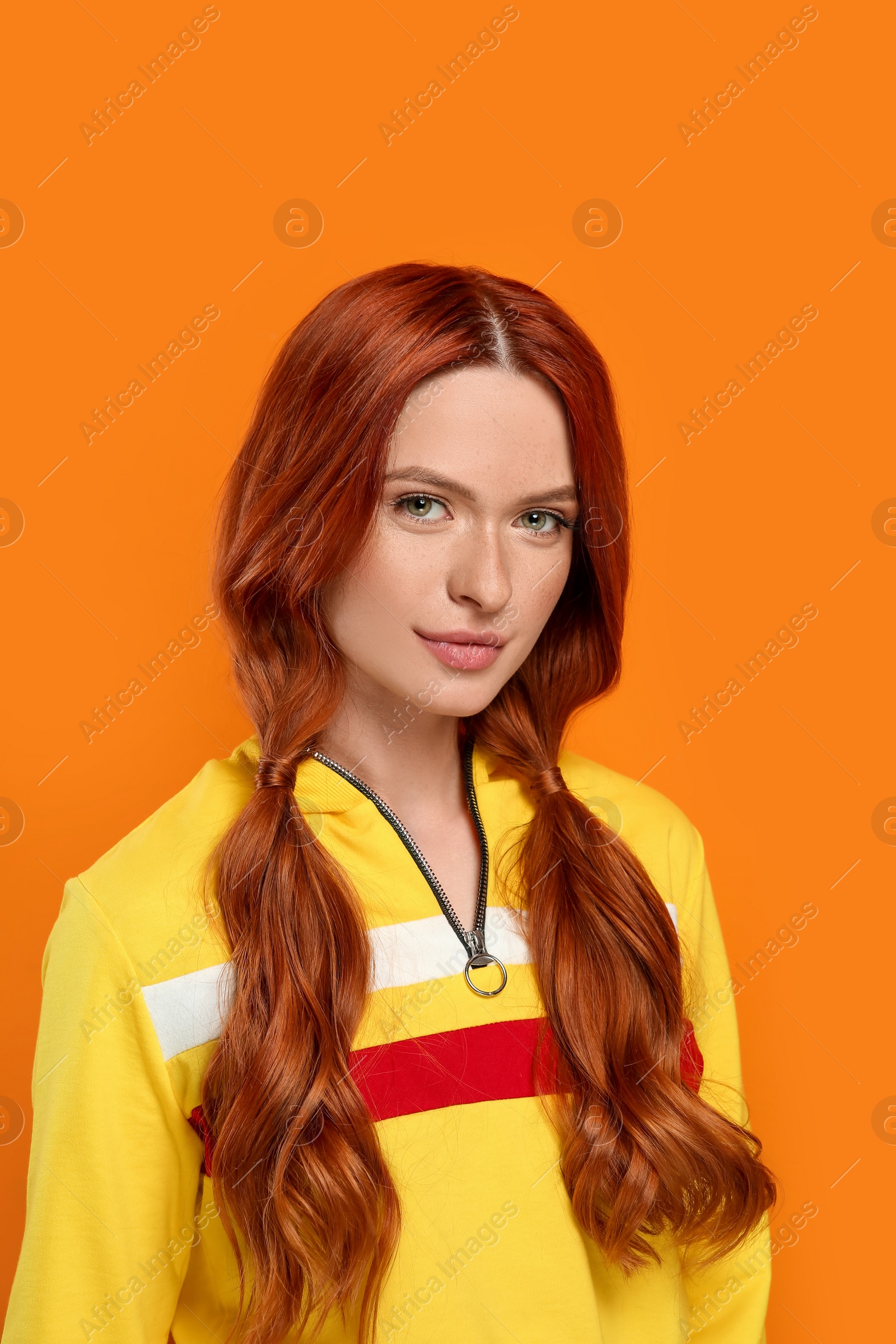 Photo of Portrait of beautiful woman on orange background