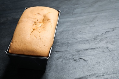 Photo of Tasty pear bread on black slate table, closeup. Homemade cake