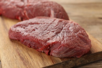 Photo of Pieces of raw beef meat on table, closeup