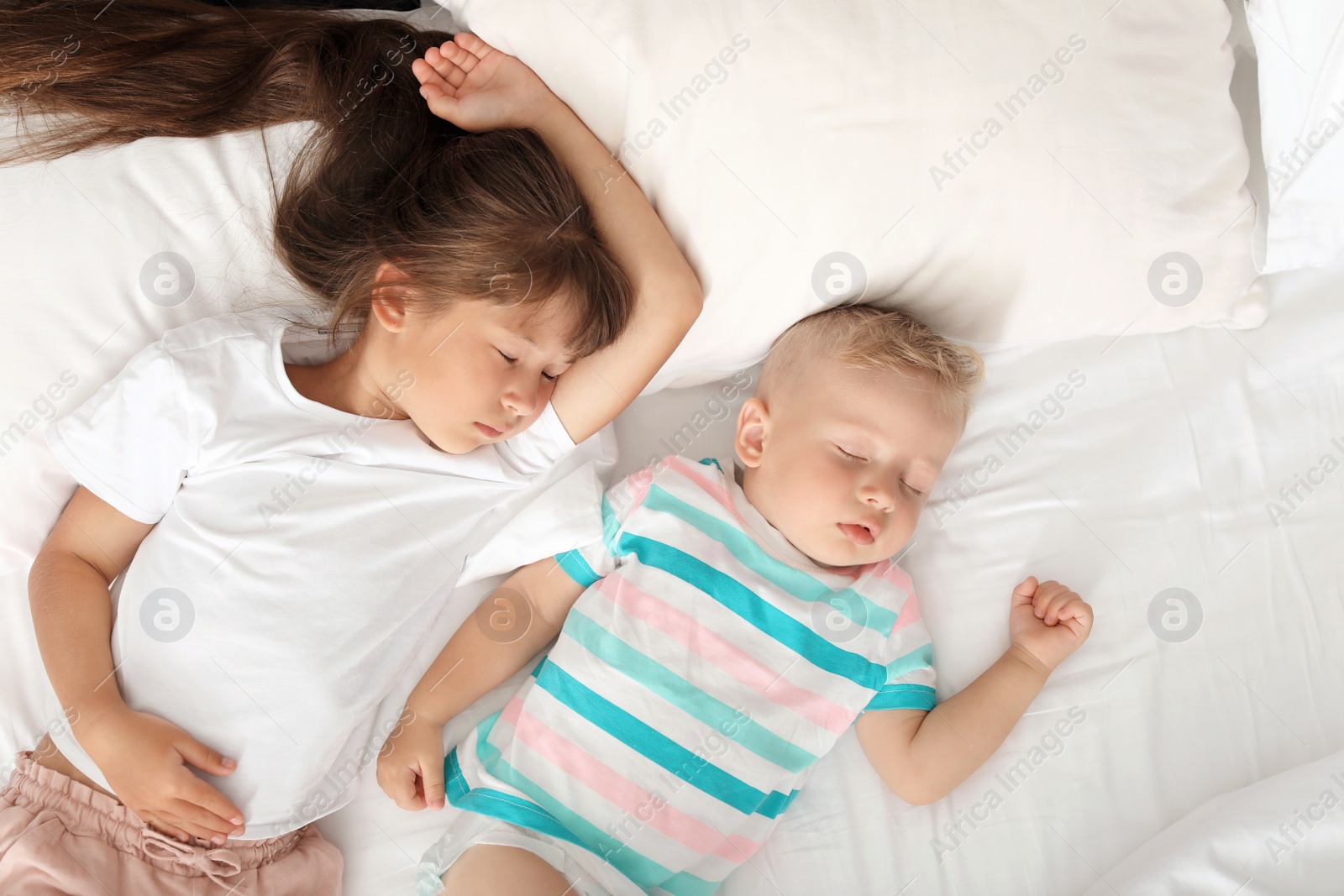 Photo of Little children sleeping in bed at home