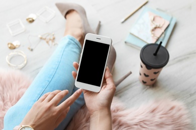 Woman using smartphone with blank screen, closeup. Mock up for design