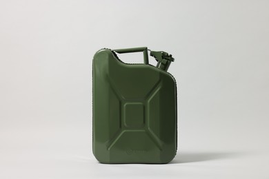 Photo of Green metal canister on light grey background