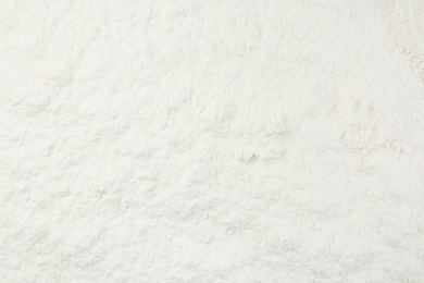 Photo of Pile of organic flour as background, top view