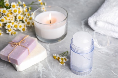 Photo of Composition with natural crystal alum deodorant on light grey marble table