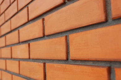 Photo of Texture of orange brick wall as background, closeup view