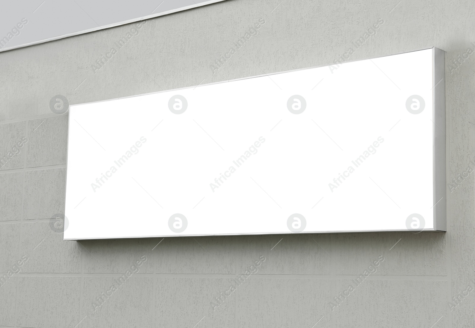 Photo of Blank lightbox poster on wall outdoors. Advertising board design
