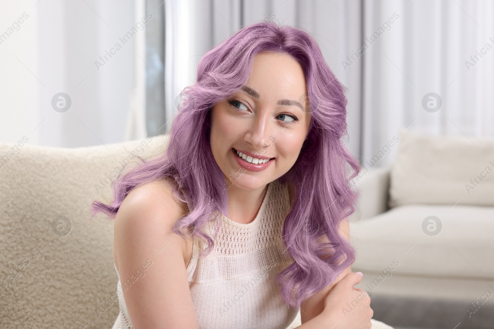 Image of Trendy hairstyle. Young woman with colorful dyed hair at home