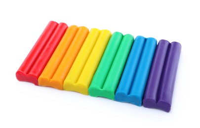Photo of Many different colorful plasticine pieces on white background