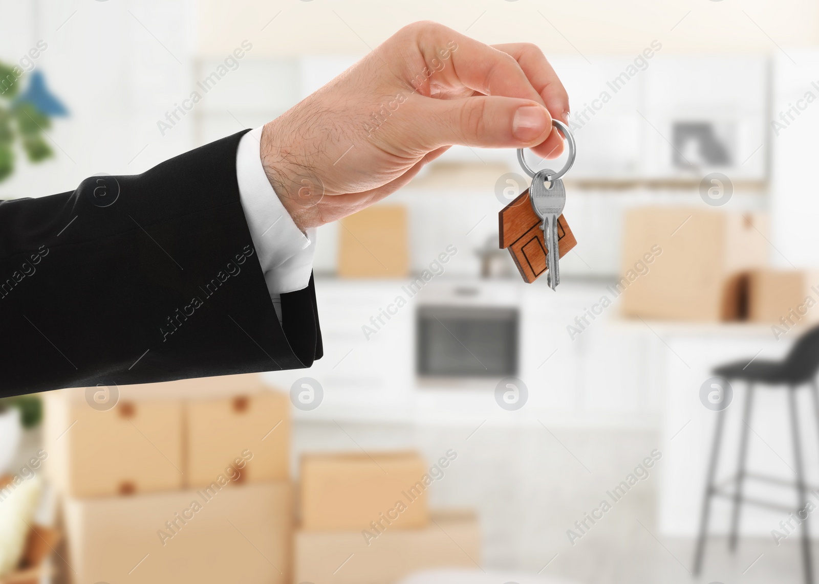 Image of Man with key in new modern apartment, closeup