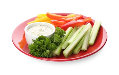 Photo of Plate with dip sauce, celery and other vegetable sticks isolated on white