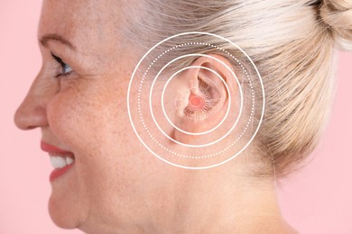 Image of Mature woman with hearing problem on pink background, closeup 