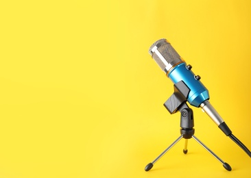 Photo of Condenser microphone on color background, space for text