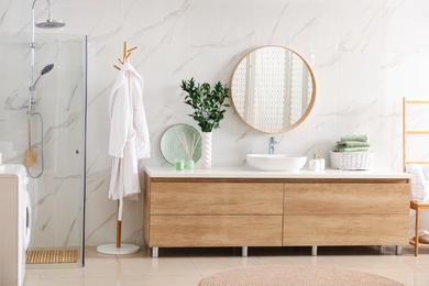 Modern bathroom interior with stylish mirror and vessel sink