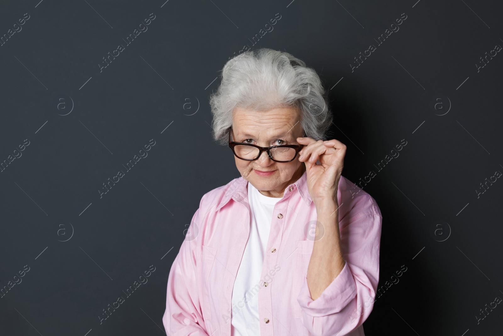 Photo of Portrait of mature woman on black background