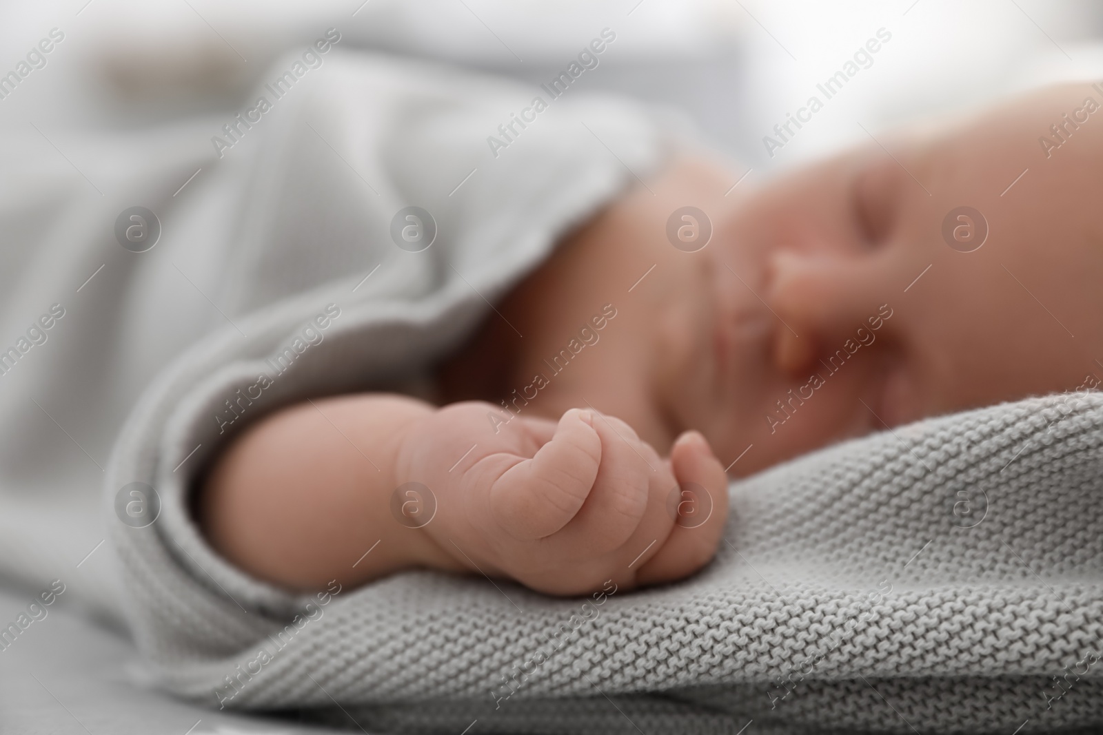 Photo of Cute little baby sleeping on bed, closeup