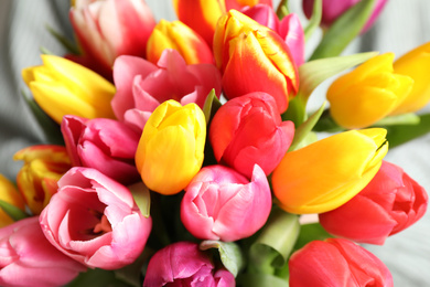Photo of Beautiful spring tulips on light background, closeup