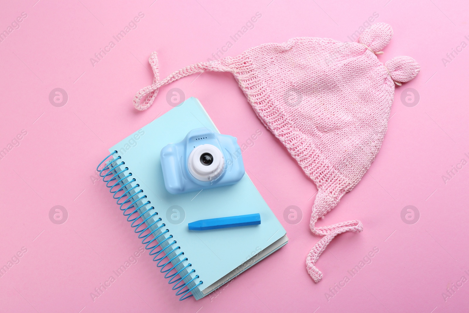 Photo of Flat lay composition with little photographer's toy camera on pink background