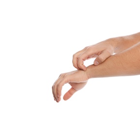 Photo of Young man scratching arm on white background, closeup. Annoying itch