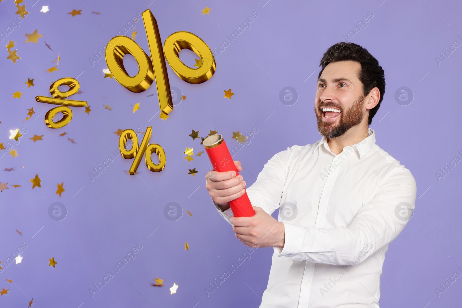 Image of Discount offer. Happy man blowing up party popper on violet background. Confetti and percent signs in air