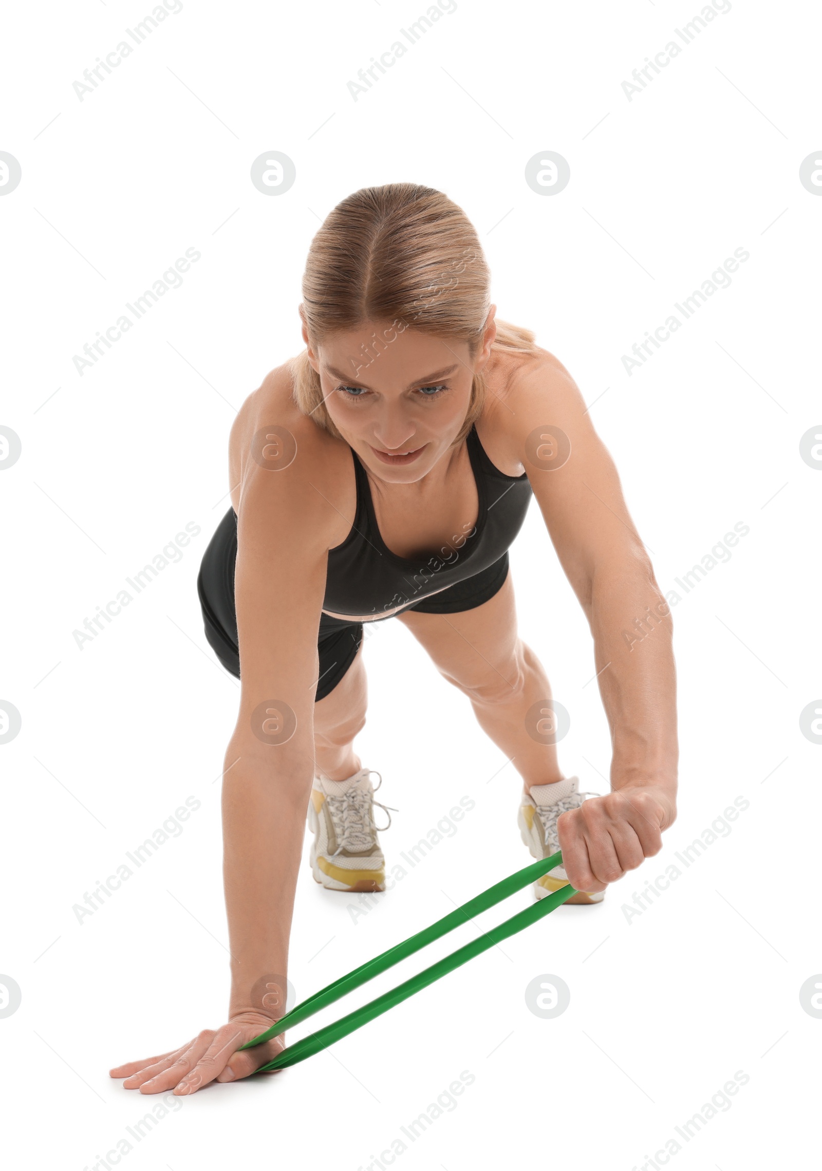 Photo of Woman exercising with elastic resistance band on white background