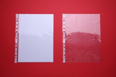 Photo of Punched pockets on red background, flat lay