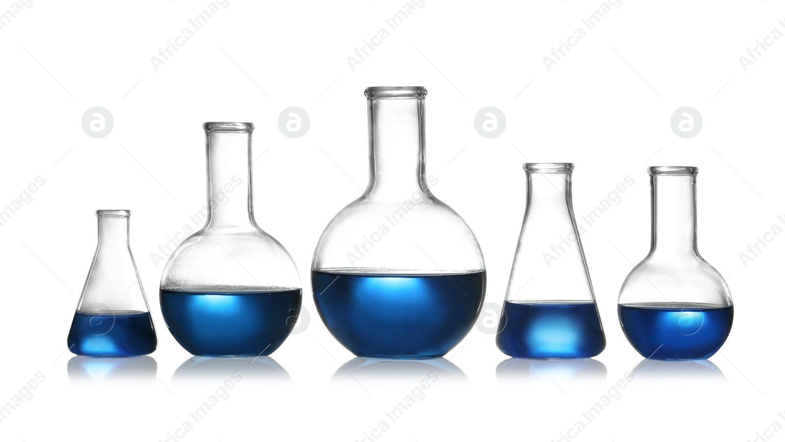 Photo of Group of chemistry glassware with liquid samples isolated on white