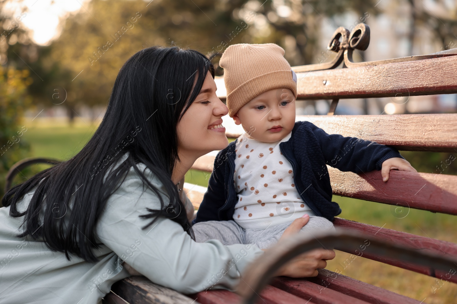 Photo of Mother and her baby on bench in park