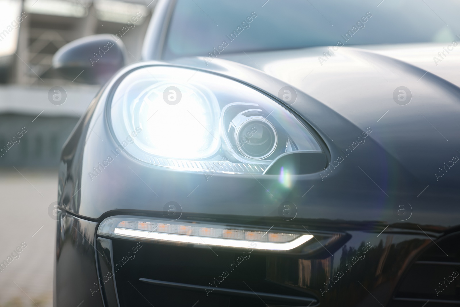 Photo of Modern black car parked outdoors, closeup view