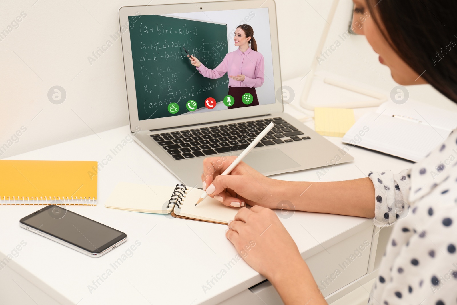 Image of Young woman using laptop for online studying at home, closeup