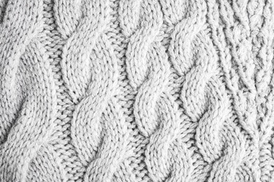 Photo of Grey knitted sweater as background, closeup view