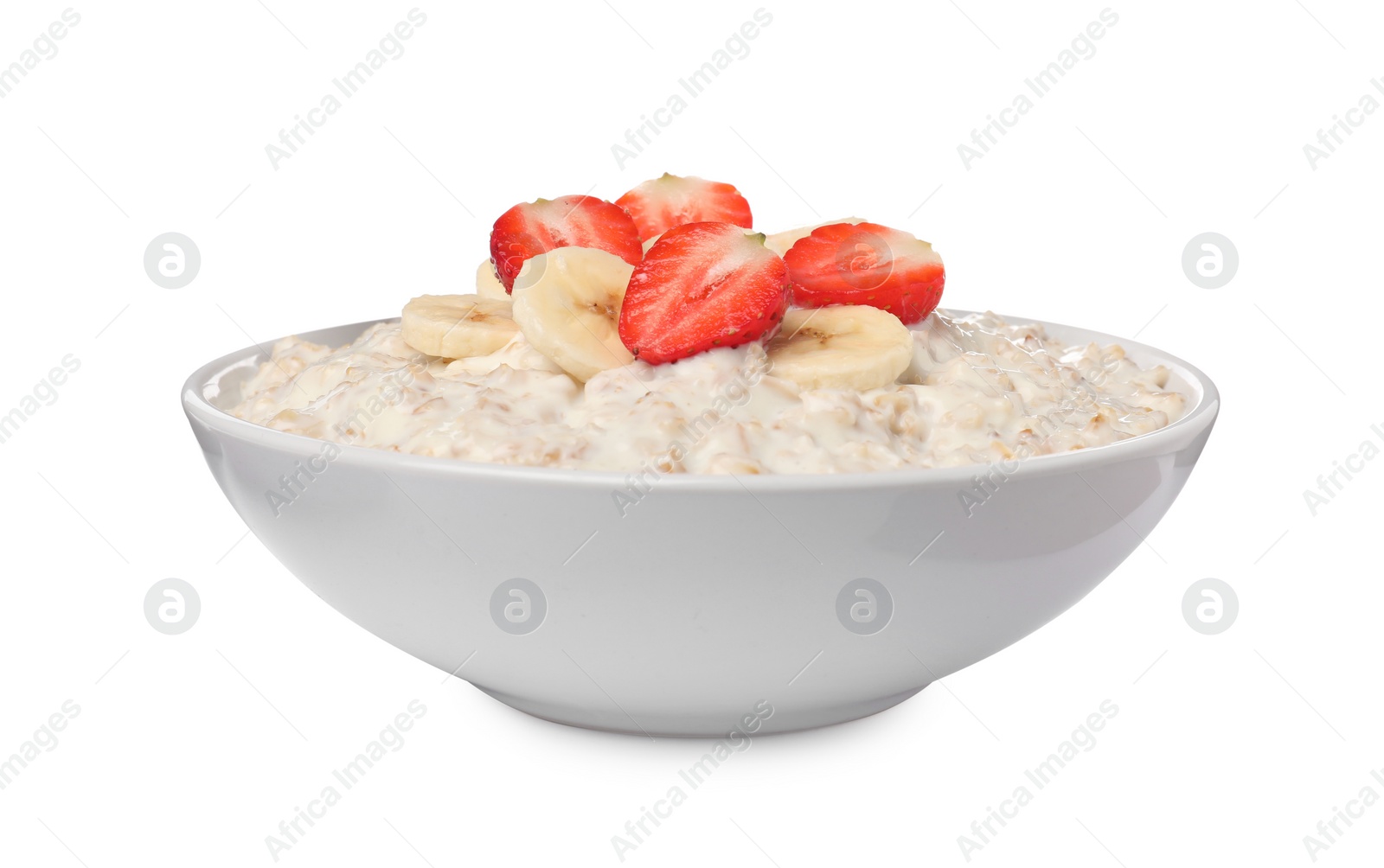 Photo of Tasty boiled oatmeal with banana and strawberries in bowl isolated on white