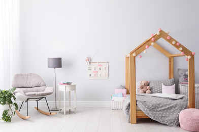 Stylish child room interior with comfortable bed