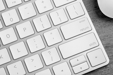 Photo of Modern computer keyboard on table, closeup view